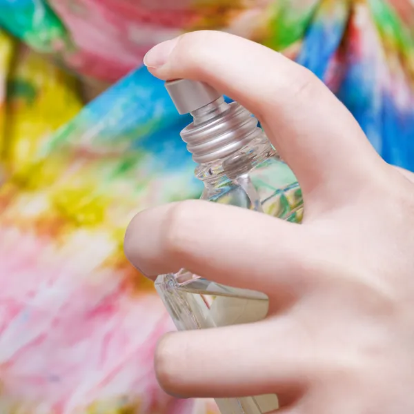 Spraying of neckerchief from bottle of perfume — Stock Photo, Image