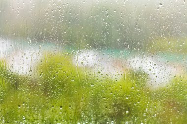 raindrops on windowpane in summer day clipart
