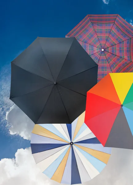 Four different open umbrellas with dark blue sky — Stock Photo, Image