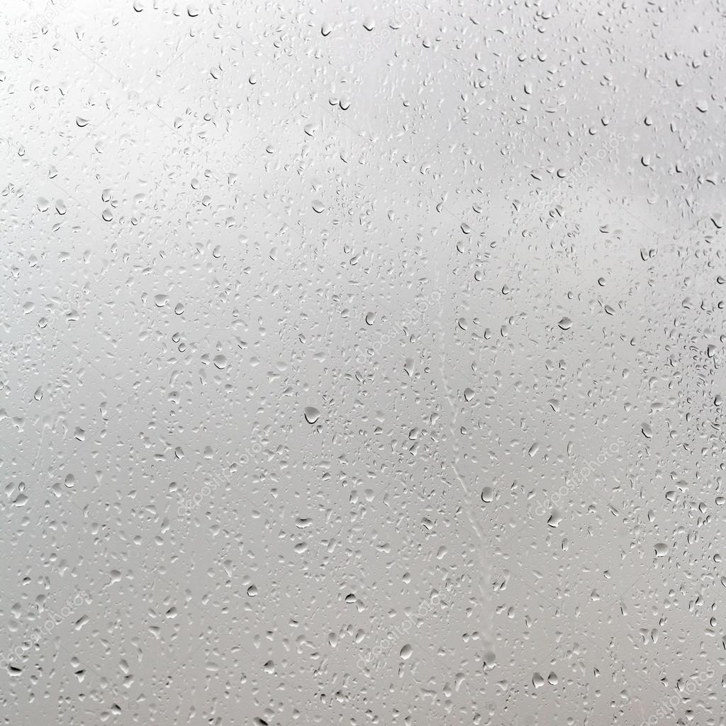 rain drops on window pane in cloudy day