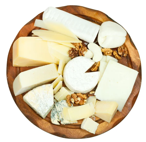 Above view of wooden plate with various cheeses — Stock Photo, Image