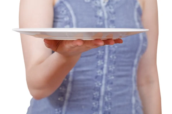 woman holds empty white plate on hand