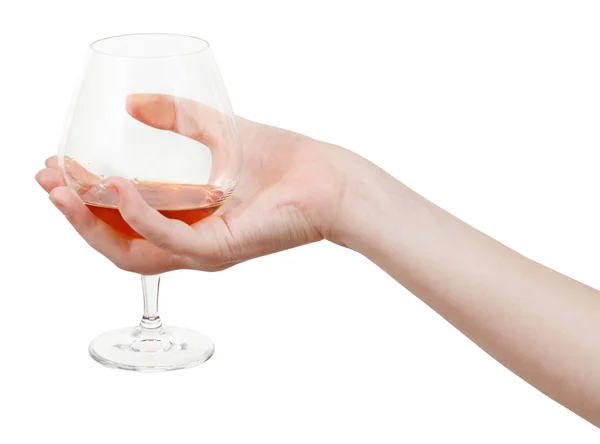 Hand holds glass goblet with brandy — Stock Photo, Image