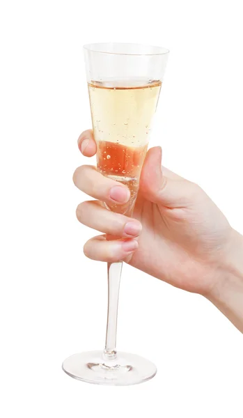 Mão segura taça de vidro com champanhe — Fotografia de Stock