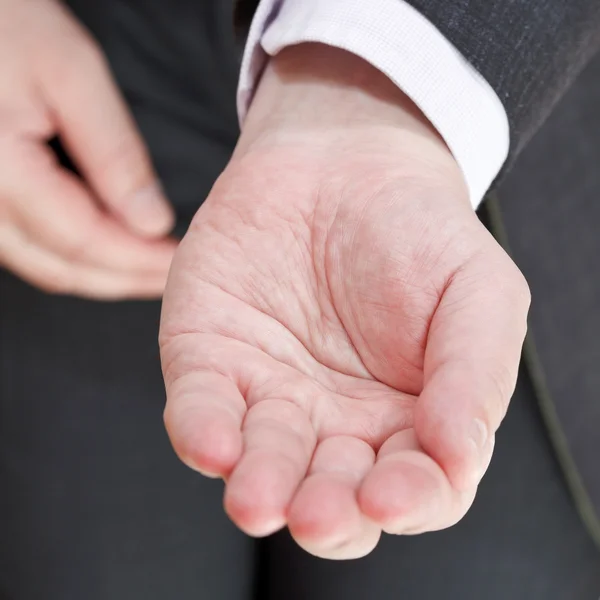 Businessman holds empty handful close up — Stock Photo, Image