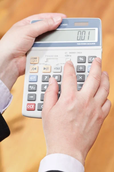 Above view of calculator in male hands — Stock Photo, Image
