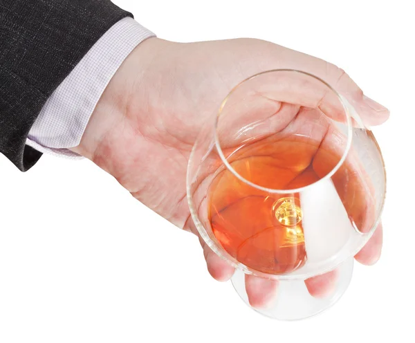 Über Ansicht des Cognacglases in der Hand des Geschäftsmannes — Stockfoto