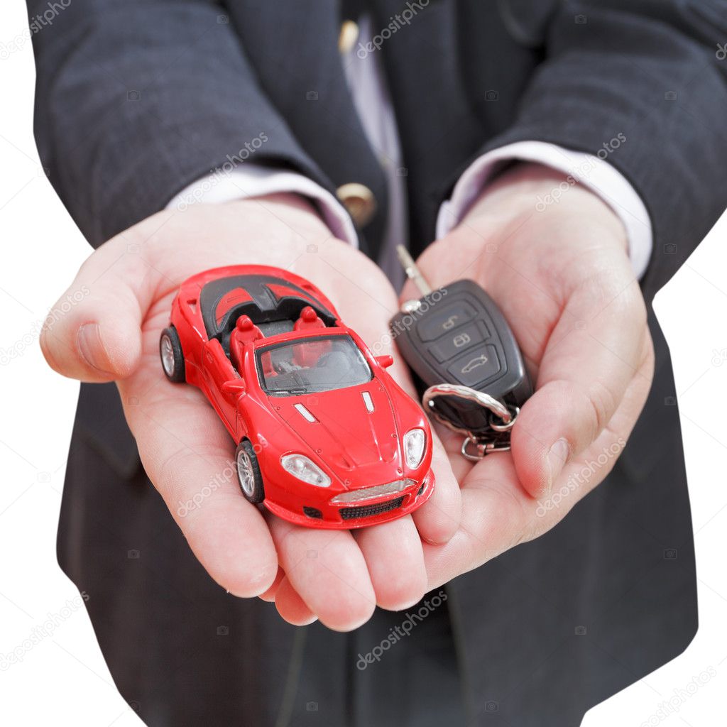 red car and key in seller's hand isolated