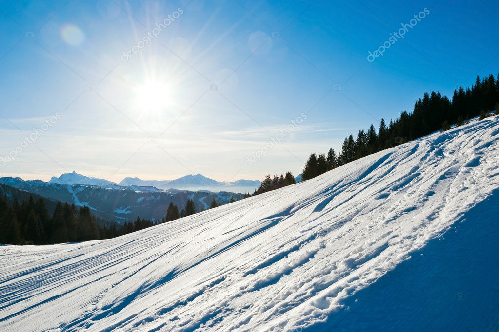 Cold snow ski slope on Alps mountain, France
