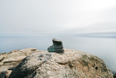 Pilgrim's boot on Cape Finisterre clipart