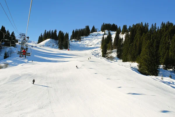 Ski lift and skiing tracks on snow Alps mountains — Stock Photo, Image