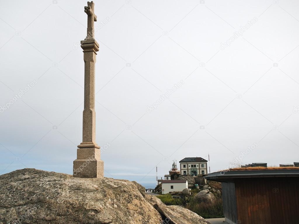 cross and view of lighthouse on Cape Finisterre