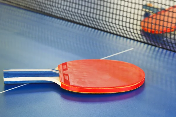 Duas raquete de tênis vermelho na mesa de ping pong — Fotografia de Stock