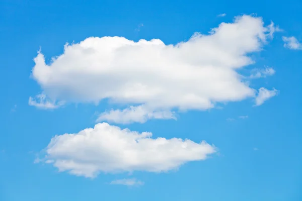 Two puffy white clouds in blue sky — Stock Photo, Image