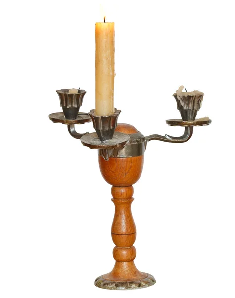 Тройной подсвечник с одной горящей свечой — стоковое фото