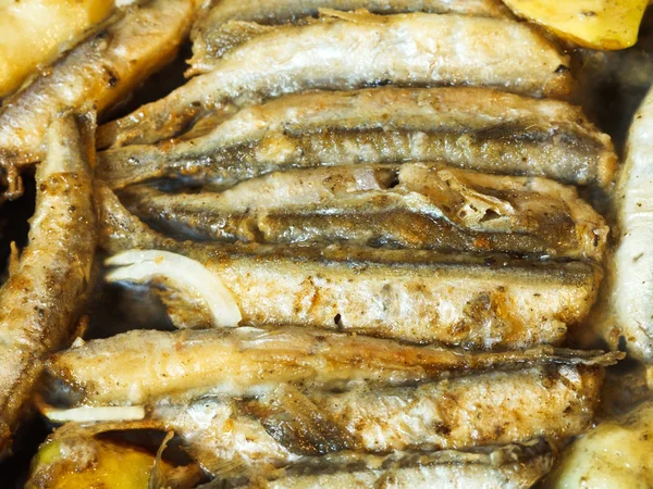 Frying capelin fish in oil in frypan — Stock Photo, Image