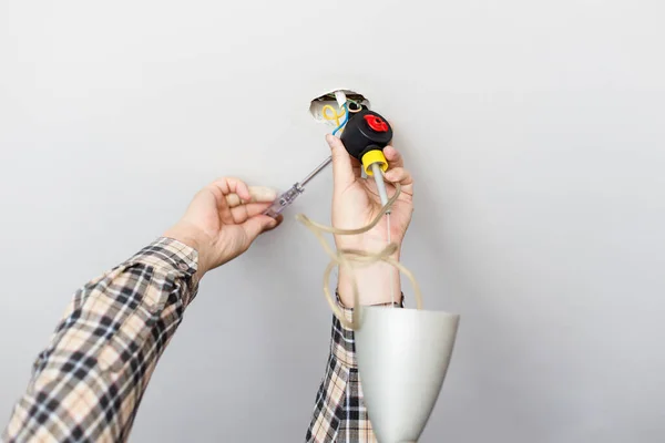 Man Repairing Defected Ceiling Lamp Home — Stock Photo, Image