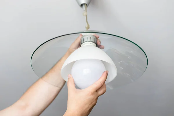 Man Replaces Bulb Ceiling Lamp Home — Stock Photo, Image