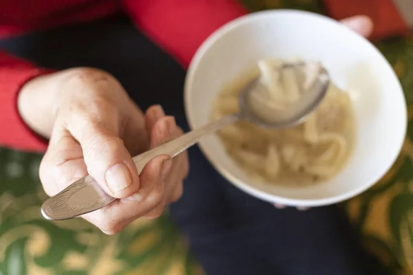 Top View Hand Old Woman Holding Tablespoon Chicken Noodle Soup — Stock Fotó