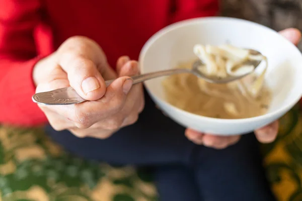 Hand Old Woman Holds Tablespoon Chicken Noodle Soup Focus Upper — Stock Fotó