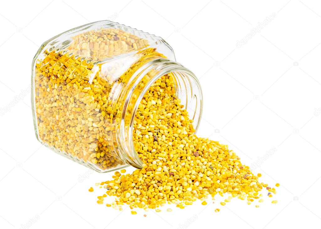 overturned glass jar with natural bee pollen isolated on white background