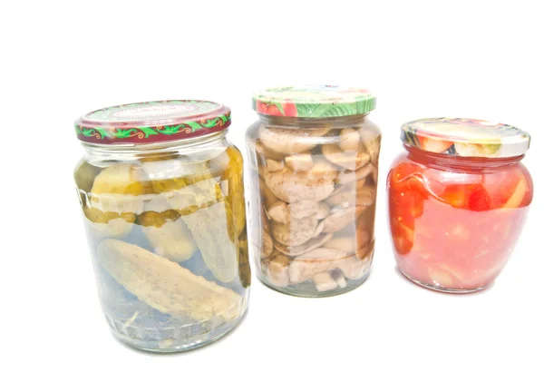 Three jars with marinated vegetables on white — Stock Photo, Image