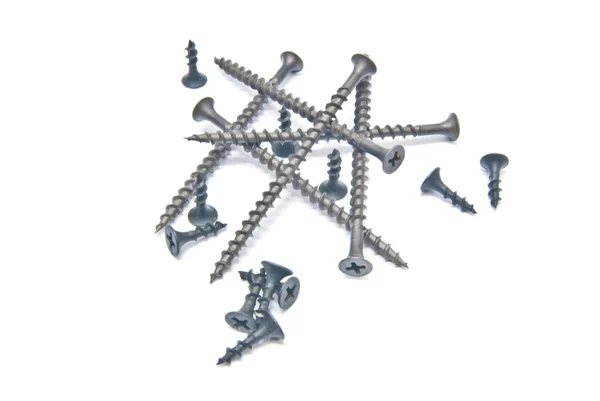 Set of black screws close-up on white Stock Image