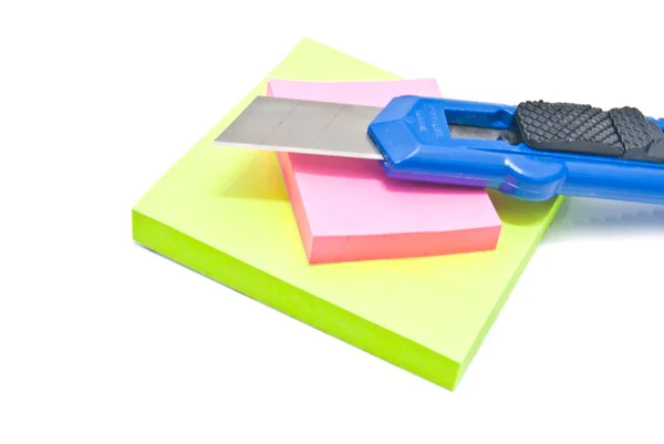 Office knife and sticky notes on white — Stock Photo, Image