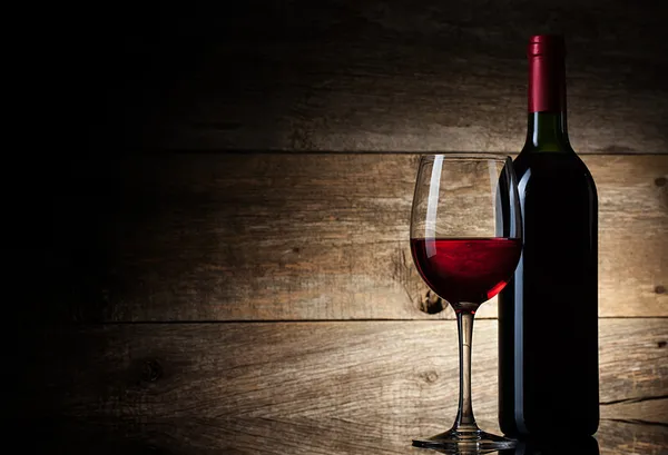 Wine glass and Bottle on a wooden background — Stock Photo, Image