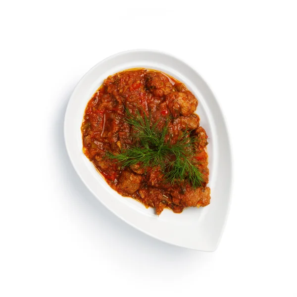 Meat in a sauce on a white plate Royalty Free Stock Images