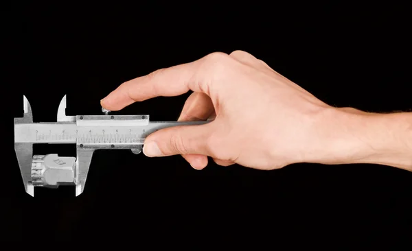 Man's hand holding a caliper during measuring — Stock Photo, Image