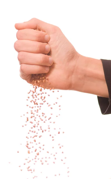 Man's hand pouring buckwheat — Stock Photo, Image