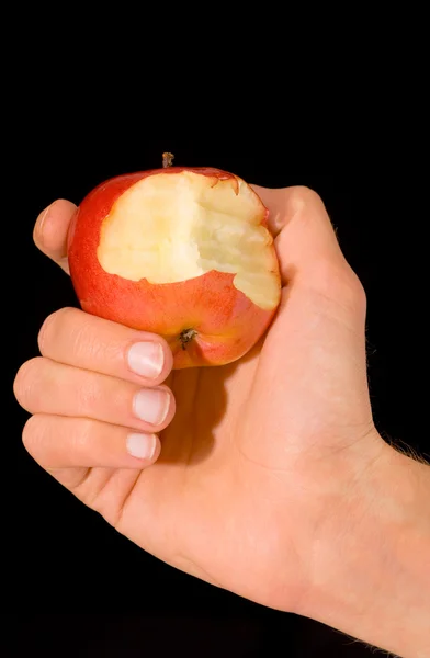 Man's hand holding a bitten apple — Stock Photo, Image