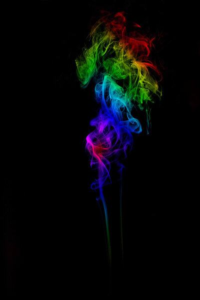 Colorful rainbow colored smoke on black background