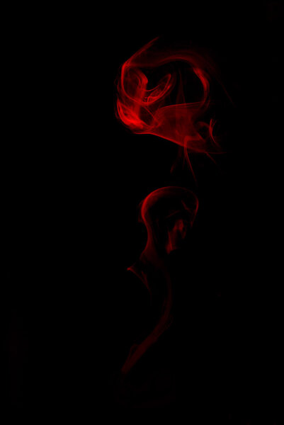 Red smoke of flower on black background