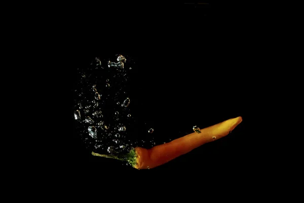 Orange paprika black — Stock Photo, Image