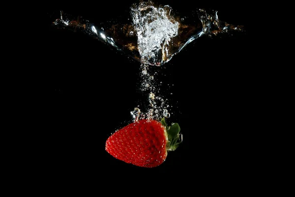 Strawberry and lot of bubbles in the water — Stock Photo, Image