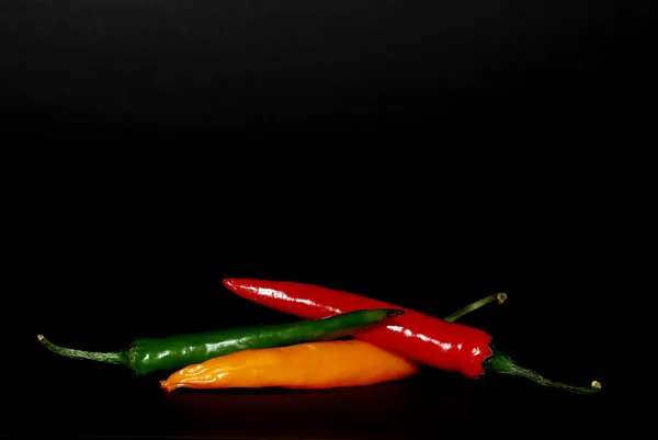 Colorful pepper on black — Stock Photo, Image
