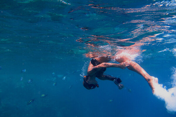 woman in bikini diving
