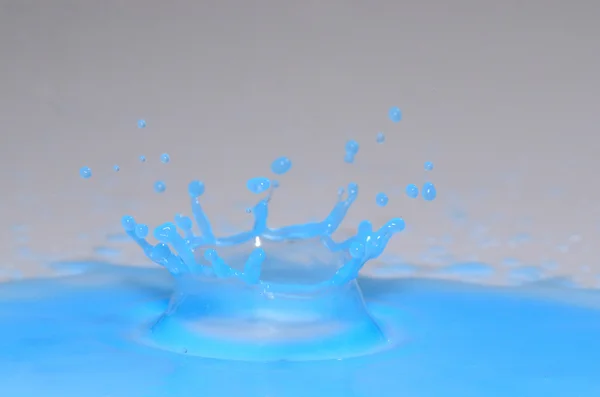 Crown in blue liquid — Stock Photo, Image