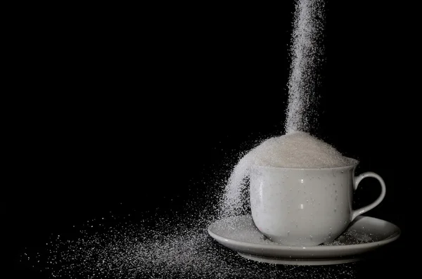 Tasse mit Zucker geht weiter — Stockfoto