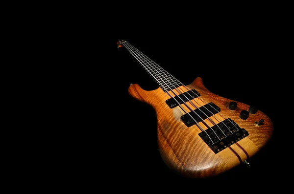 Bass guitar with black background — Stock Fotó