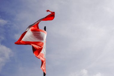 Avustralya 'da tatilde gökyüzüne bakan bir dağ kulübesinde rüzgarda dalgalanan Avustralya bayrağı.