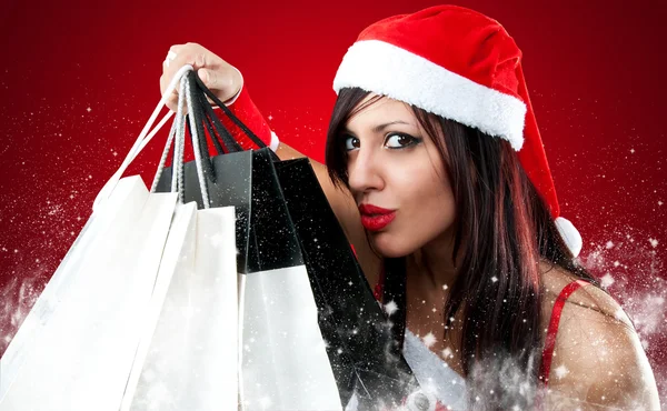 Girl wearing santa claus clothes with shopping bag — Stock Photo, Image