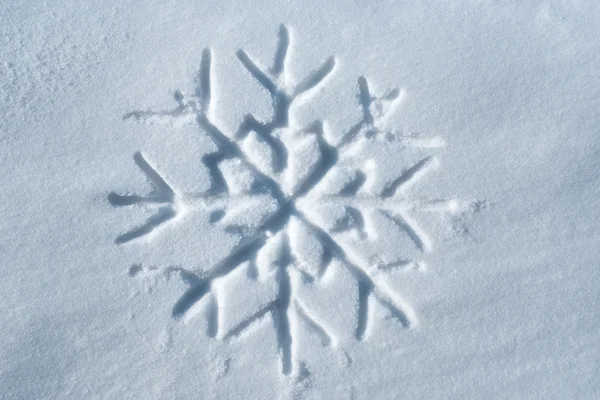 Snowflake written in snow — Stock Photo, Image