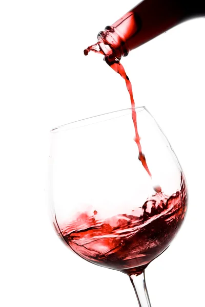 Öntés le egy pohár vörös bor Jogdíjmentes Stock Képek