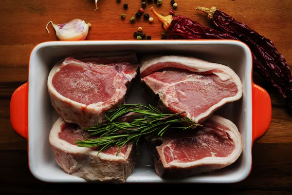 Lamb meat - fresh lamb chops with rosemary herbs — Stock Photo, Image