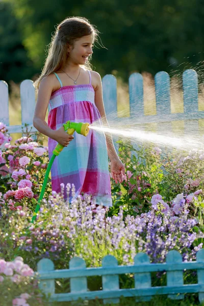 Summer fun, girl watering flowers — Stock Photo, Image