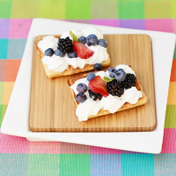 Waffles and fresh seasonal fruits with whipped cream — Stock Photo, Image