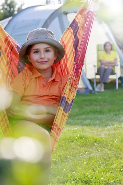 Summer in the tent - young girl with family on the camping